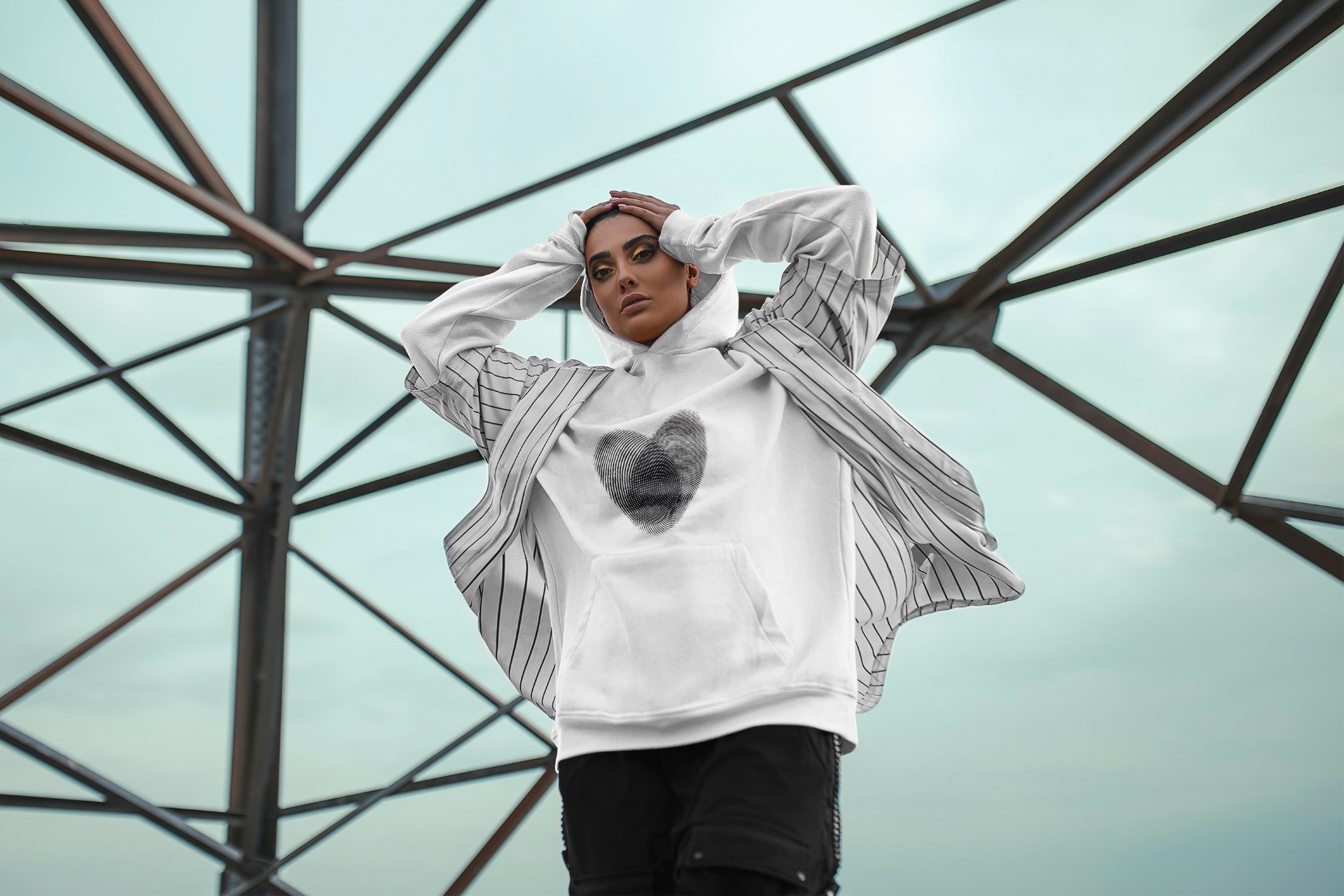 Custom hoodie with heart fingerprint design worn outdoors